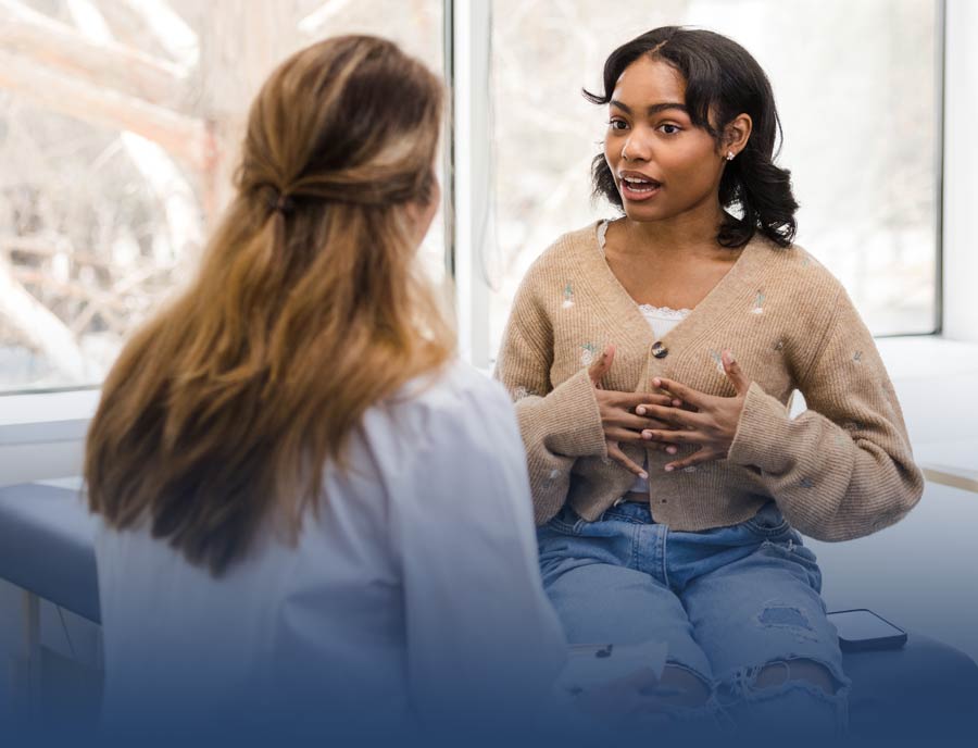 Photo of a young woman talking to her doctor
