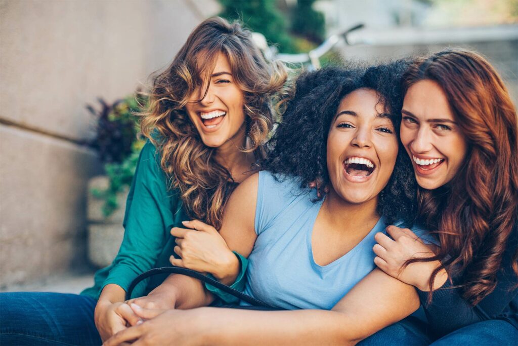 Photo of three happy girlfriends