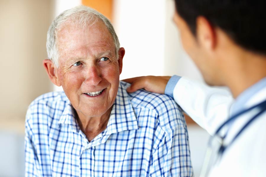 Photo of a man talking to his doctor